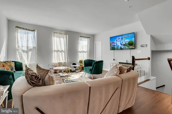 a living room with furniture a large window and a flat screen tv