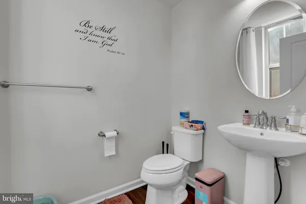 a bathroom with a sink mirror and toilet