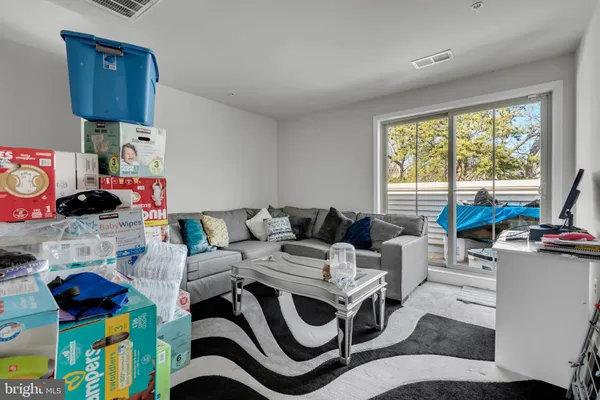 a living room with furniture and a floor to ceiling window