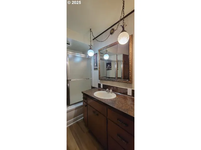 a bathroom with a shower and a mirror