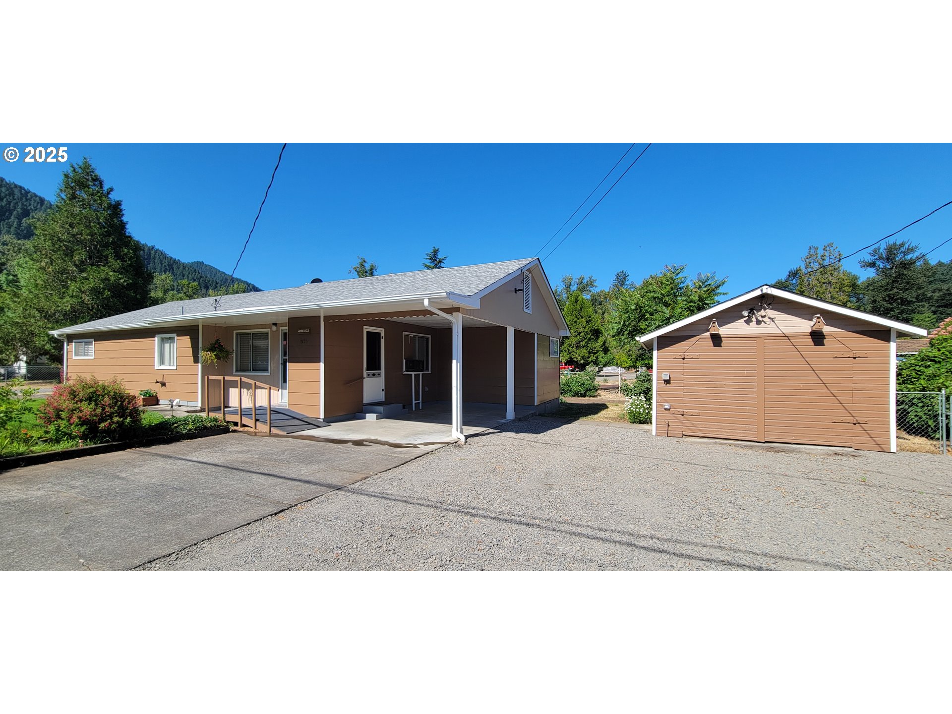 76376 River Road Oakridge, OR 97463 - Photo 2 of 38 a front view of a house with a yard and garage