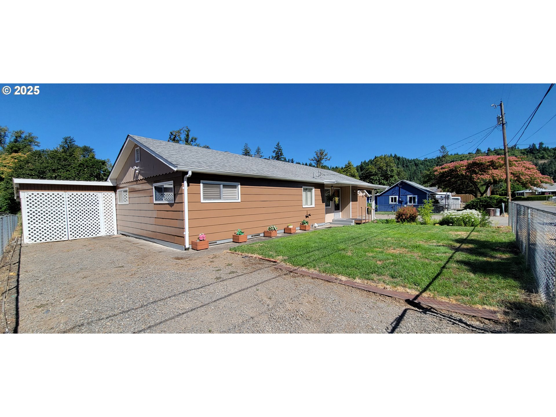 76376 River Road Oakridge, OR 97463 - Photo 5 of 38 a front view of a house with a yard and garage