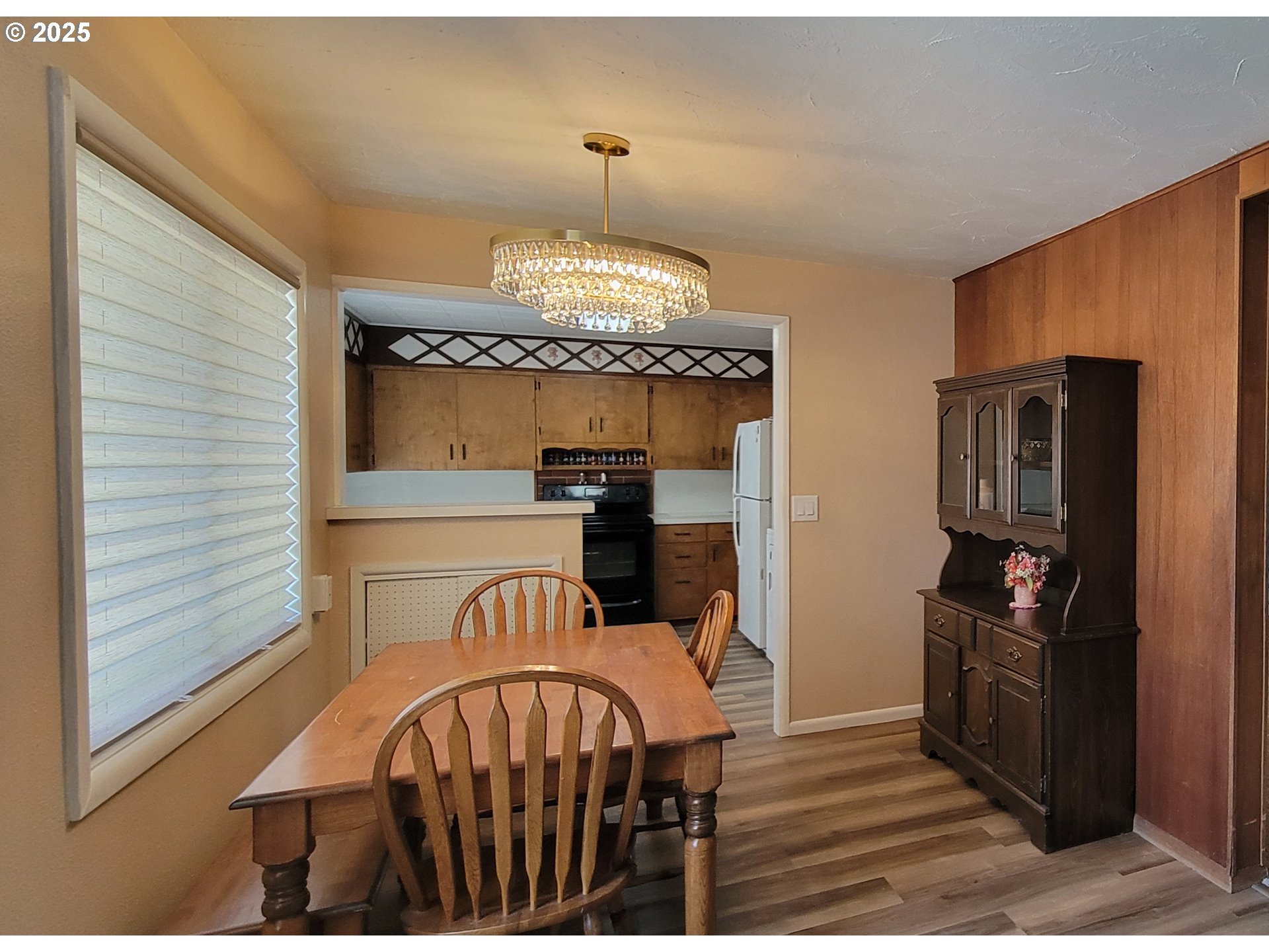 76376 River Road Oakridge, OR 97463 - Photo 7 of 38 a view of a dining room with furniture a chandelier and wooden floor