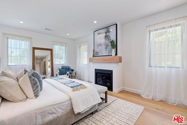 a bedroom with a bed and a fireplace