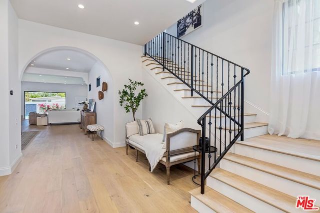 a view of entryway with wooden floor and stairs