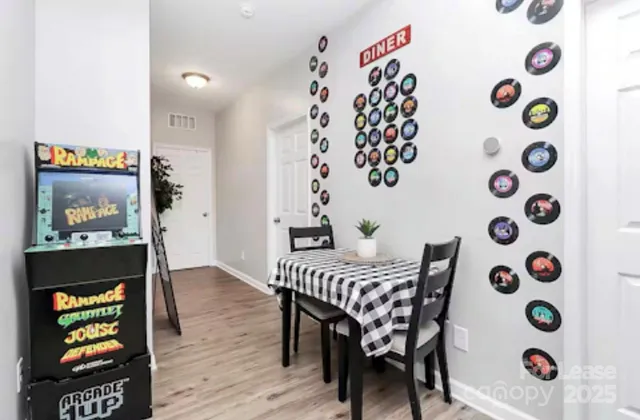 a view of a room with furniture and wooden floor