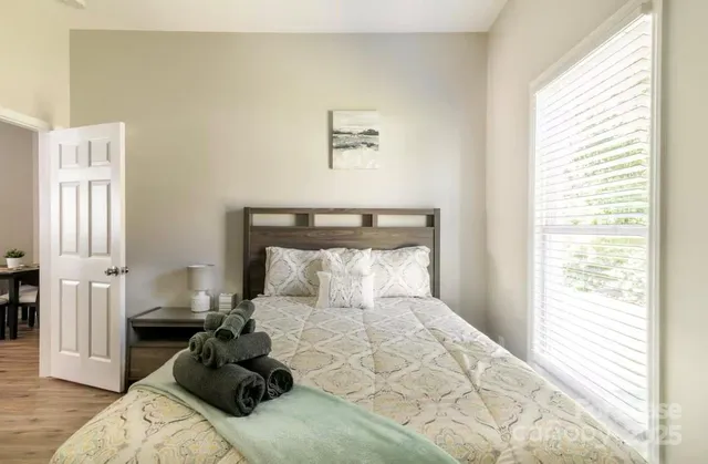 a bedroom with a bed and wooden floor