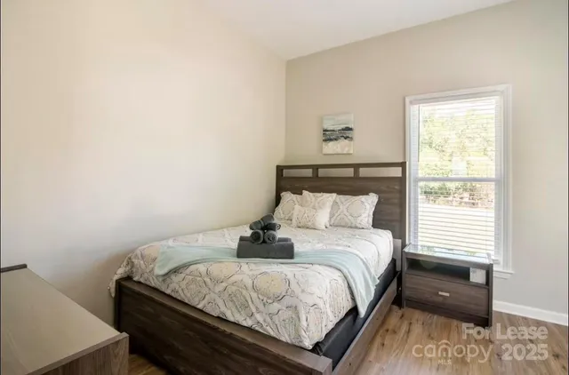 a bedroom with a bed and window