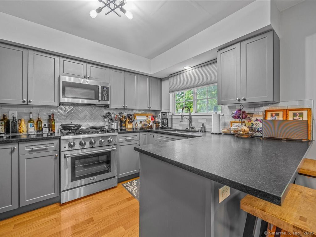 3 Apple Way Madison, CT 06443 - Photo 12 of 31 a kitchen with kitchen island granite countertop a stove cabinets and sink