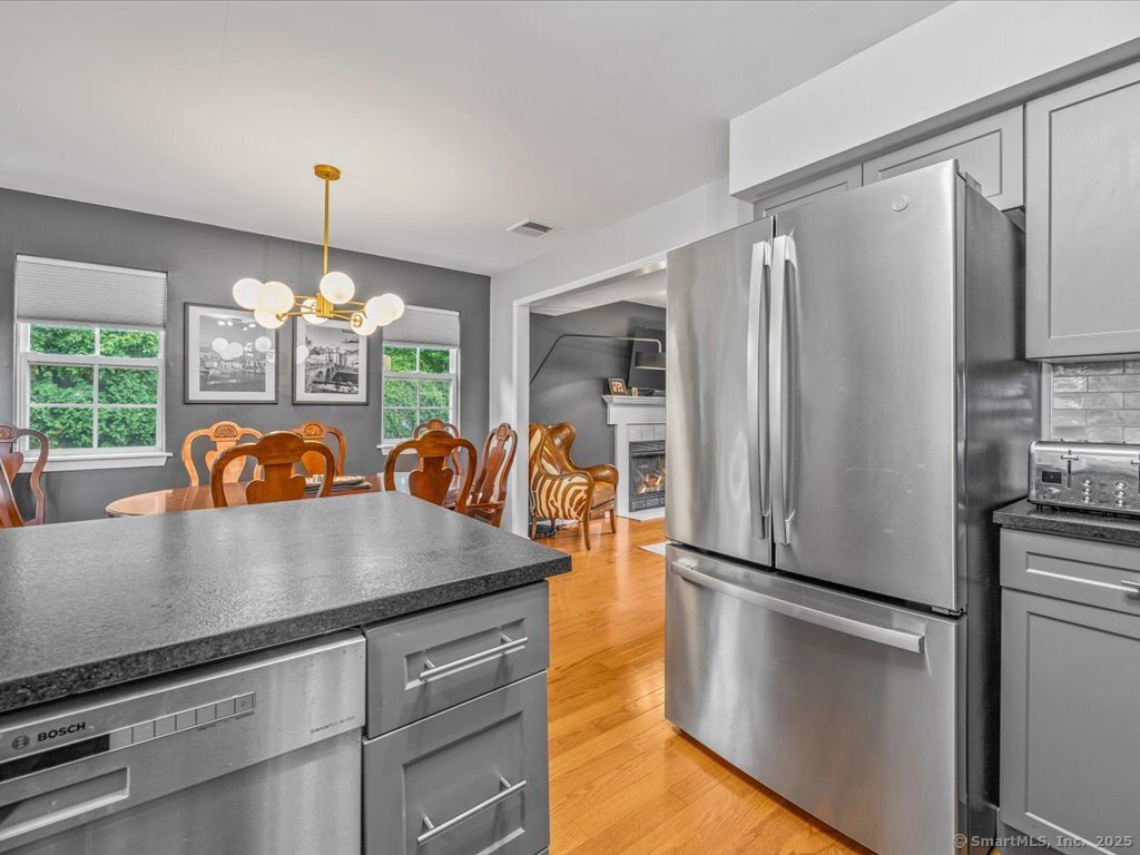 3 Apple Way Madison, CT 06443 - Photo 14 of 31 a view of a kitchen with a refrigerator a stove and a chandelier