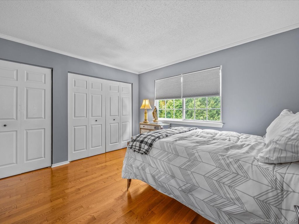 3 Apple Way Madison, CT 06443 - Photo 21 of 31 a bed sitting in a spacious bedroom next to a window