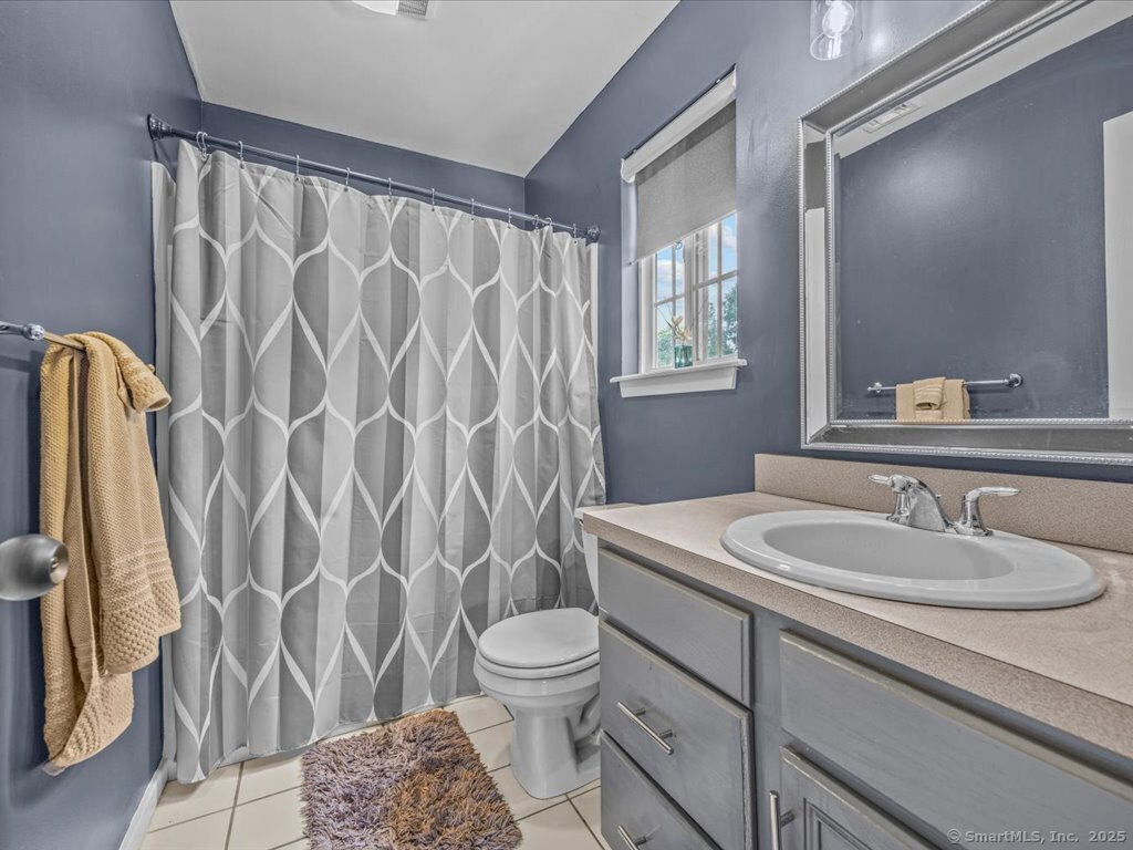 3 Apple Way Madison, CT 06443 - Photo 23 of 31 a bathroom with a sink a toilet and a mirror