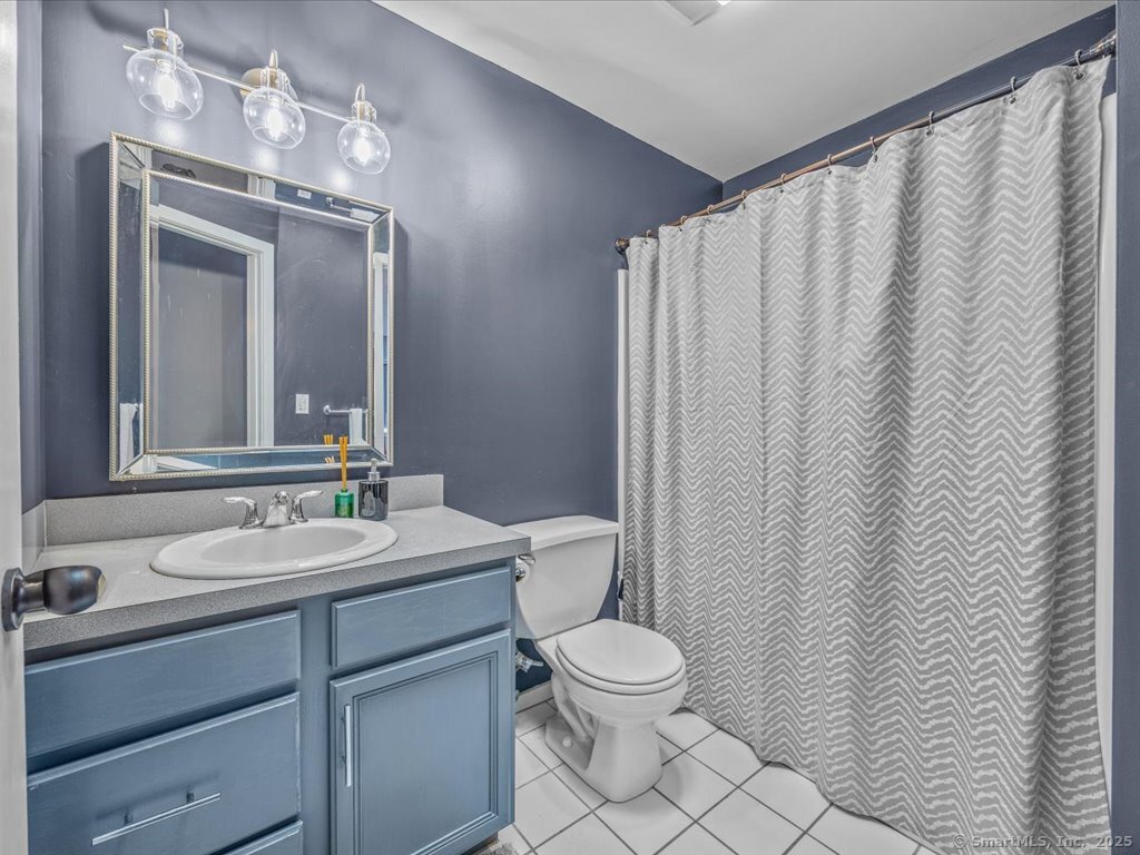 3 Apple Way Madison, CT 06443 - Photo 25 of 31 a bathroom with a toilet a sink and a mirror