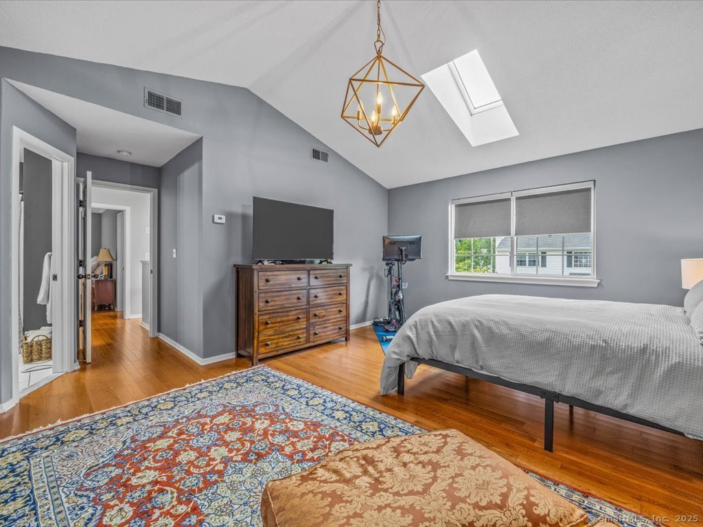 3 Apple Way Madison, CT 06443 - Photo 27 of 31 a bedroom with a bed and wooden floor