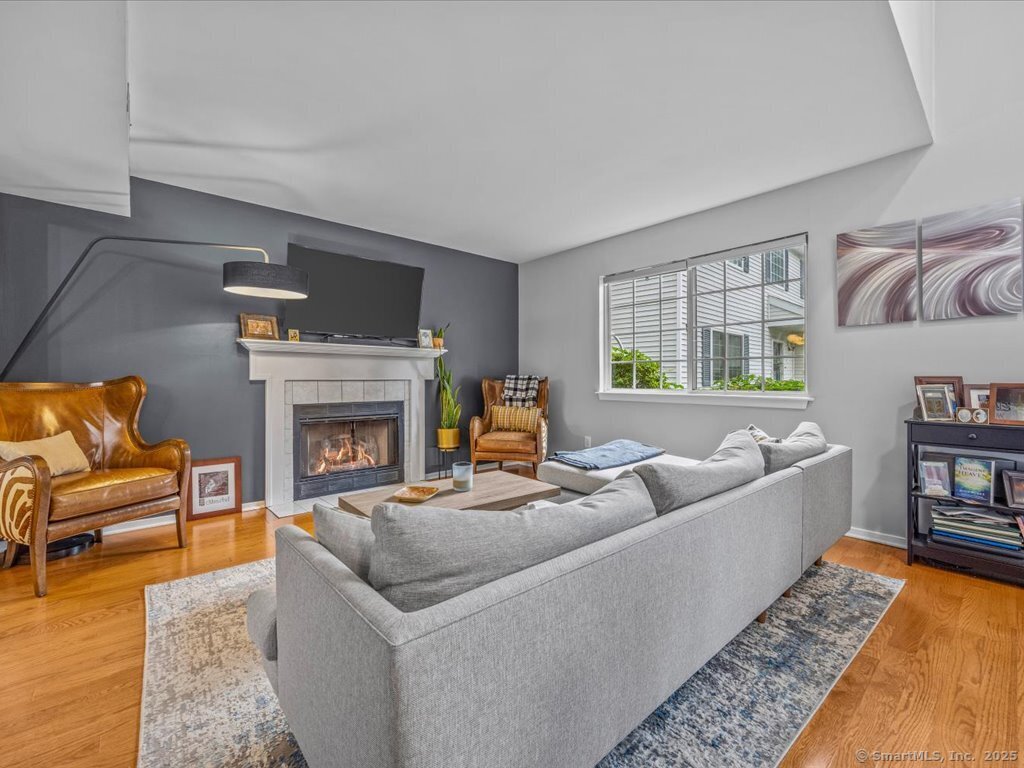 3 Apple Way Madison, CT 06443 - Photo 5 of 31 a living room with furniture and a fireplace