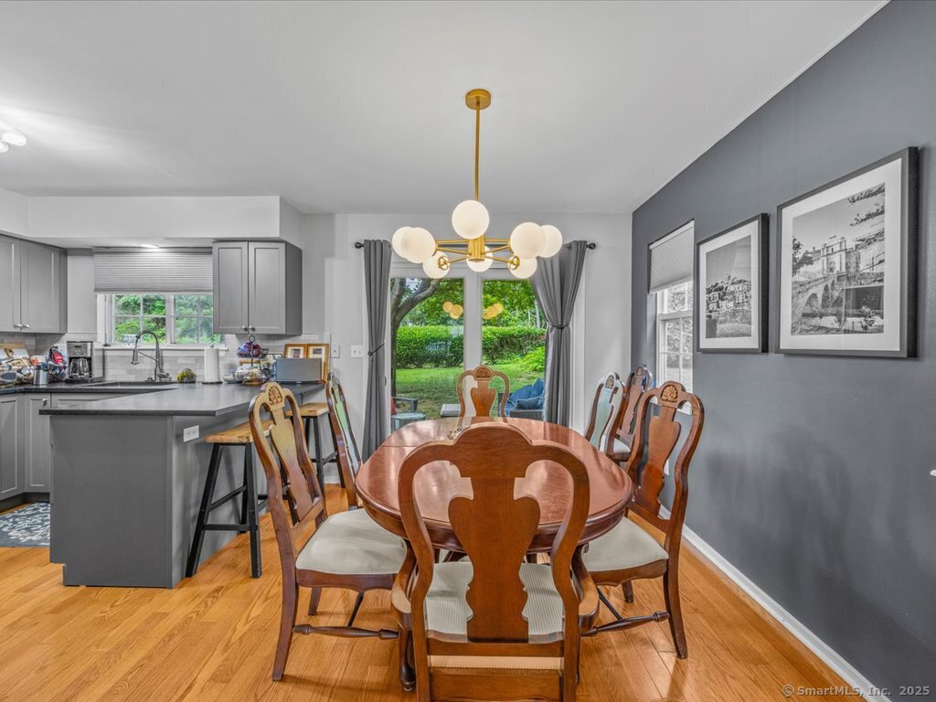 3 Apple Way Madison, CT 06443 - Photo 8 of 31 a dining room filled chandelier and wooden floor