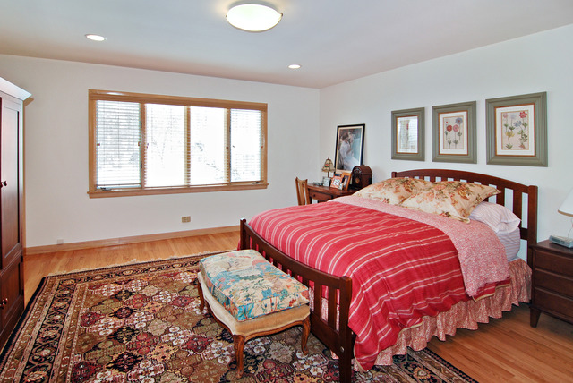 349 Uvedale Road Riverside, IL 60546 - Photo 8 of 23 a bed sitting in a bedroom next to a window