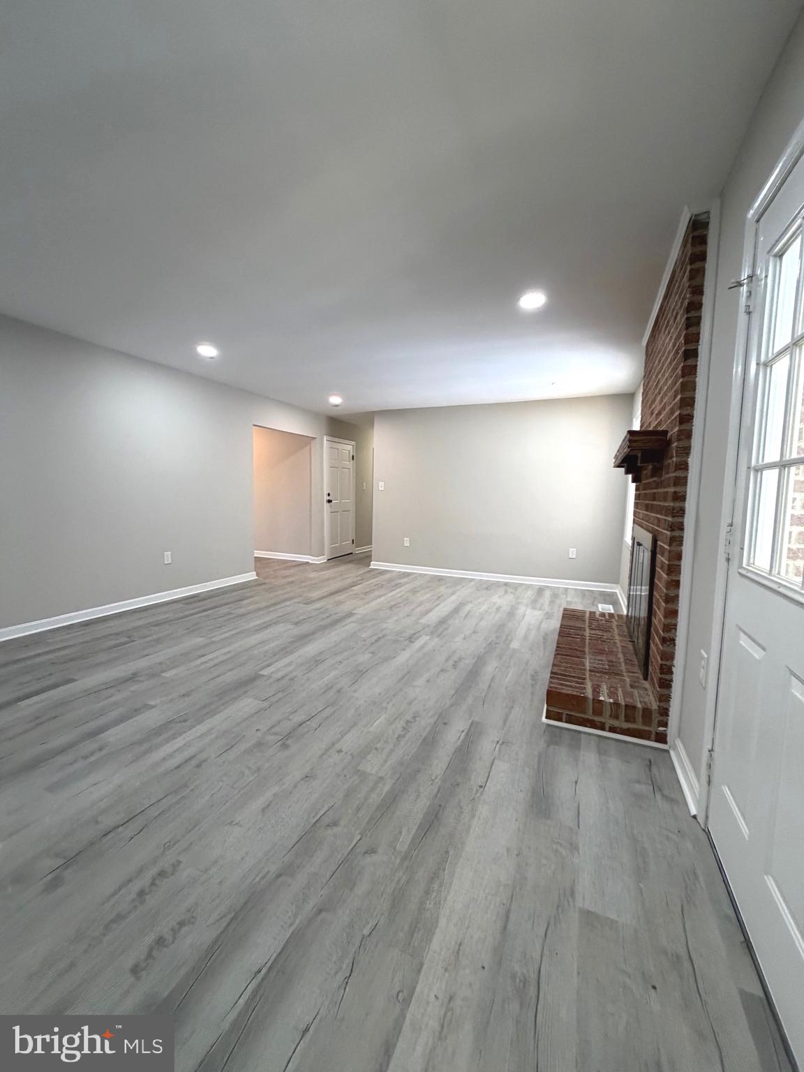 12926 Couples Place Waldorf, MD 20601 - Photo 13 of 29 an empty room with wooden floor and windows