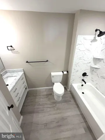 a bathroom with a bathtub sink and toilet