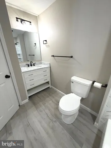 a bathroom with a toilet sink and a mirror