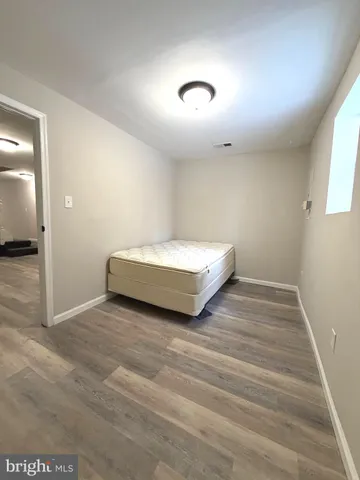 a spacious bedroom with a bed and a window