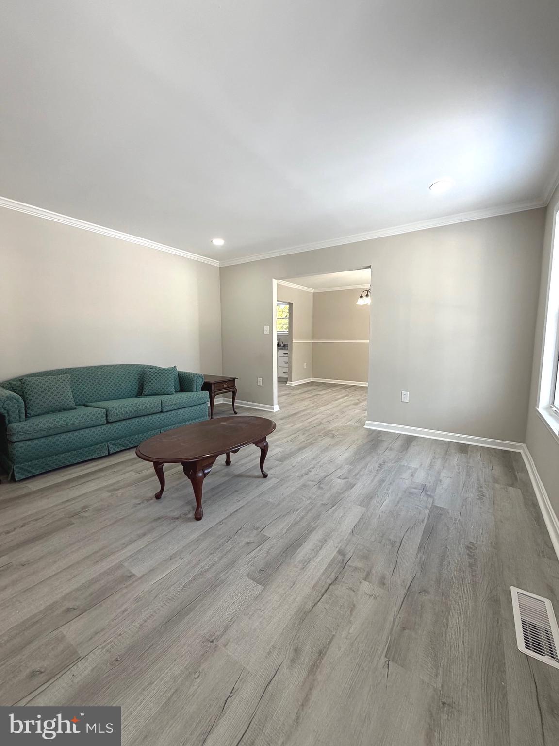 12926 Couples Place Waldorf, MD 20601 - Photo 10 of 29 a living room with furniture and a wooden floor