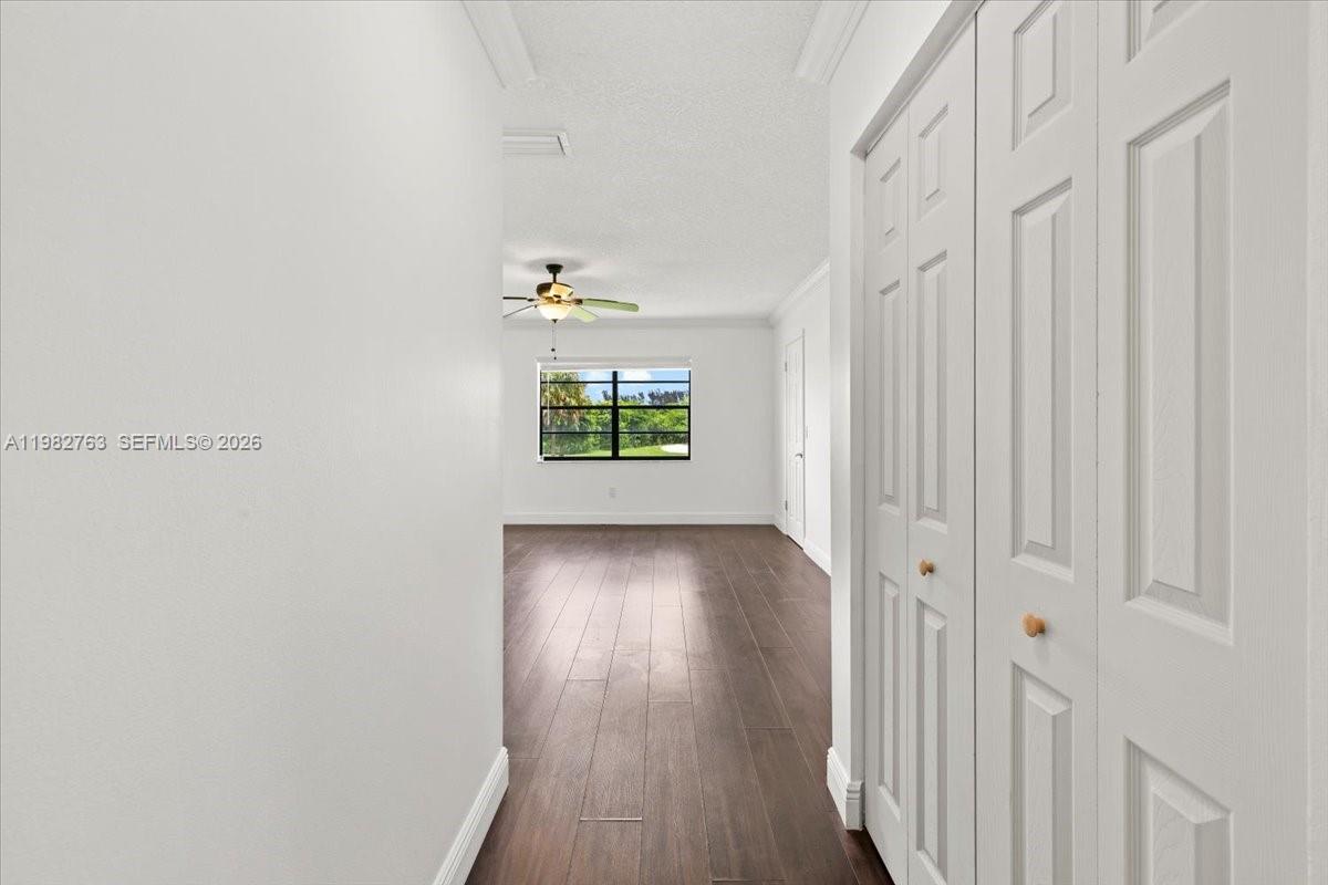 7944 Eastlake Drive, Unit D Boca Raton, FL 33433 - Photo 14 of 29 a view of an empty room with wooden floor and a window