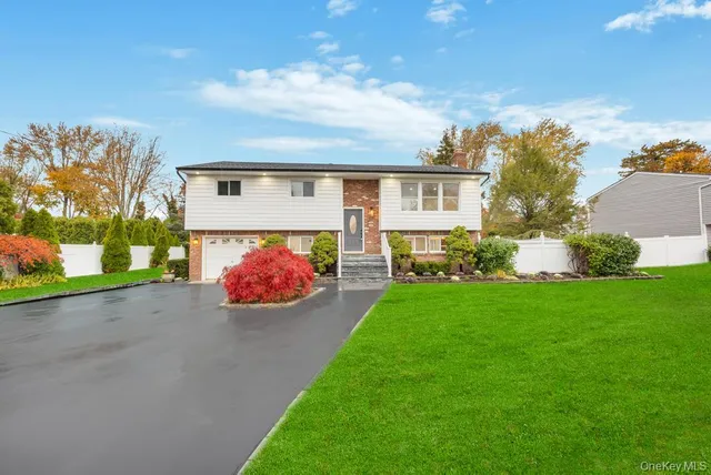 a front view of a house with a garden and yard