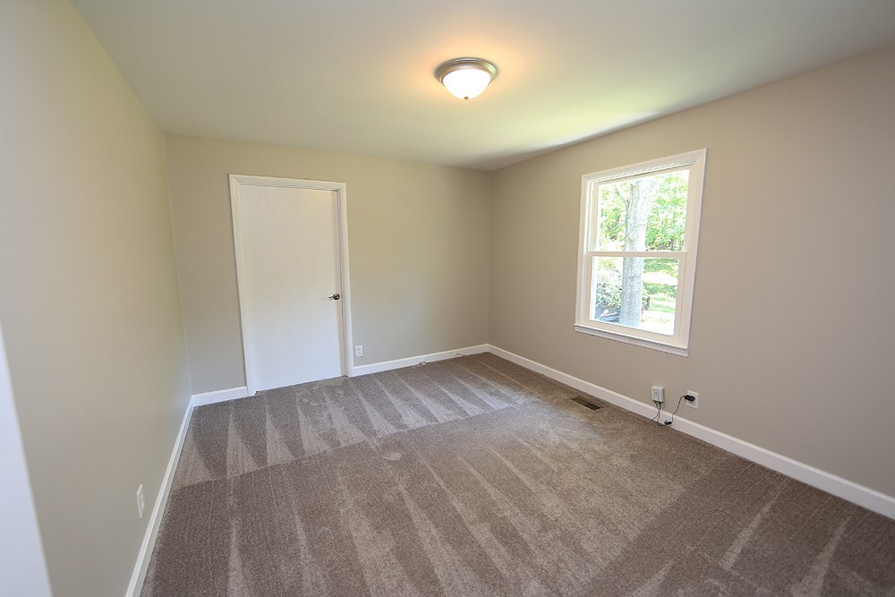 8013 Massey Chapel Road Durham, NC 27713 - Photo 11 of 17 Second bedroom - far door is access to laundry room/storage room.