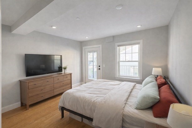 33 Boardman Street, Unit 2 Boston, MA 02128 - Photo 3 of 11 a bedroom with a bed and a flat screen tv