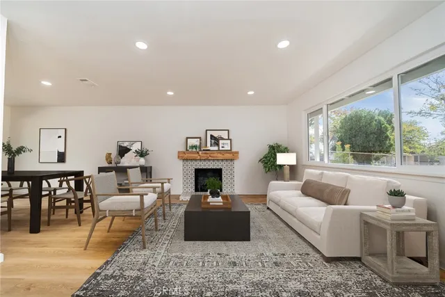 a living room with furniture a fireplace and a table