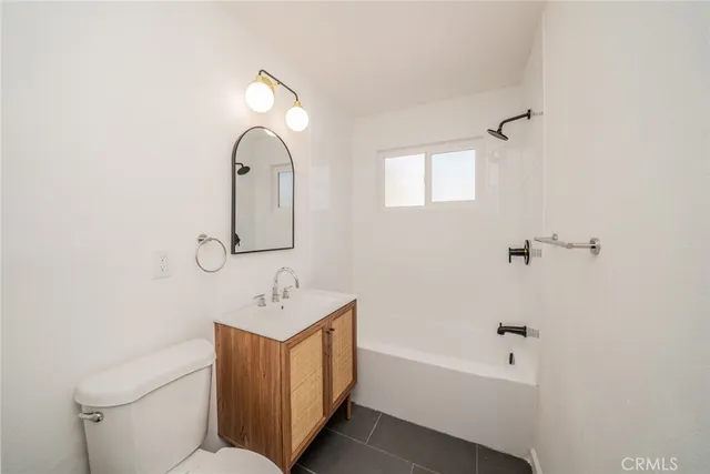 a bathroom with a sink mirror bathtub and toilet