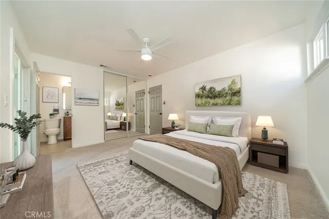 a spacious bedroom with a bed a table and couch