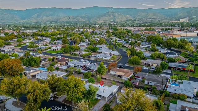 an aerial view of a city with lots of residential buildings and mountain view