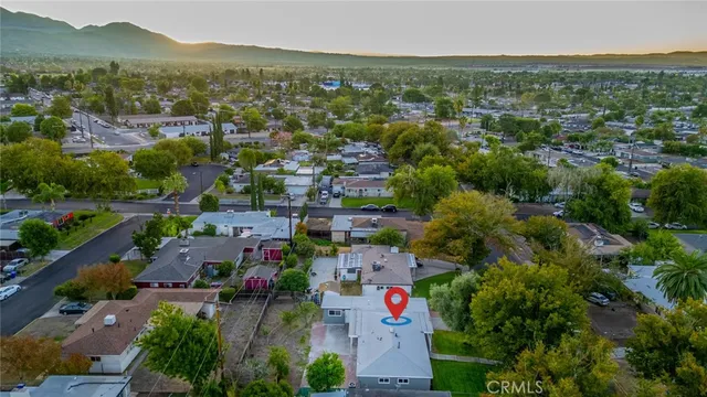 an aerial view of residential houses with outdoor space and trees