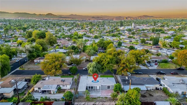 an aerial view of residential houses with outdoor space and street view