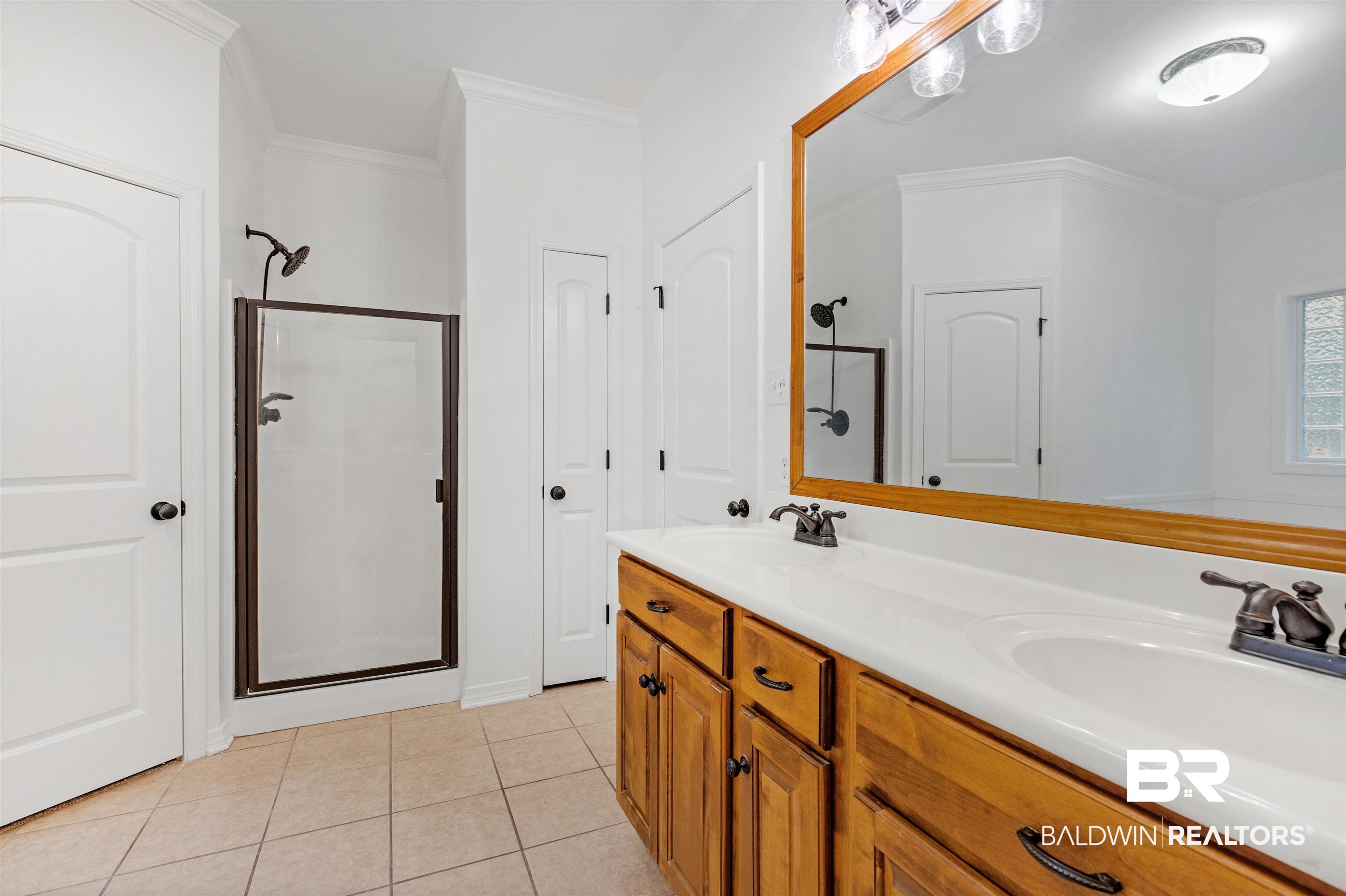 1007 Linlen Avenue Mobile, AL 36609 - Photo 17 of 21 Bathroom with ornamental molding, vanity, tile patterned floors, and a shower with shower door