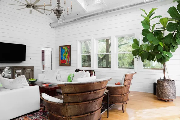 a living room with furniture and a potted plant