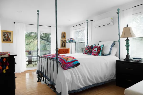 a bedroom with a bed and a window