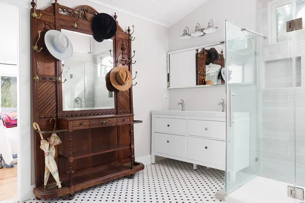 a bathroom with a sink a mirror and shower