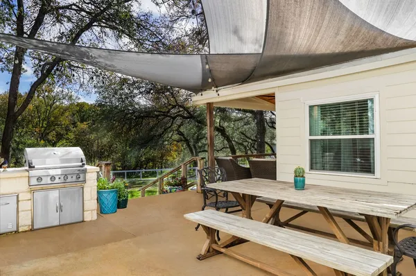 a view of a patio with a table and chairs