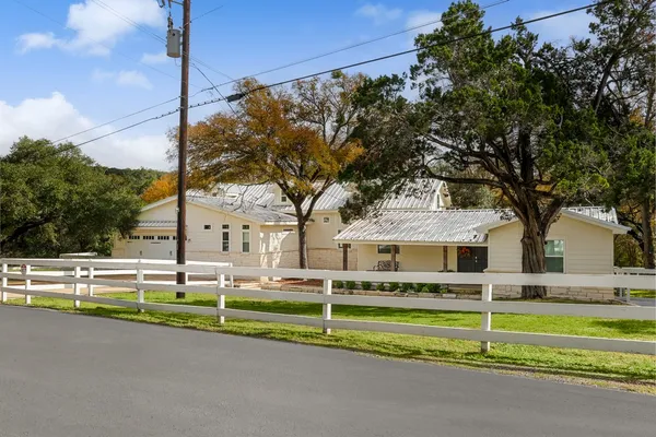 a view of a house in front of a big yard