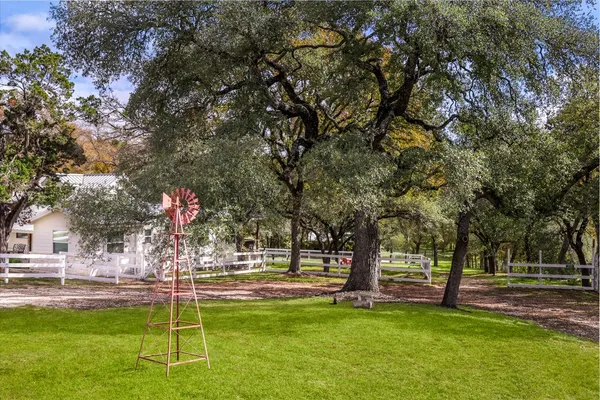 a swimming pool with outdoor seating and yard