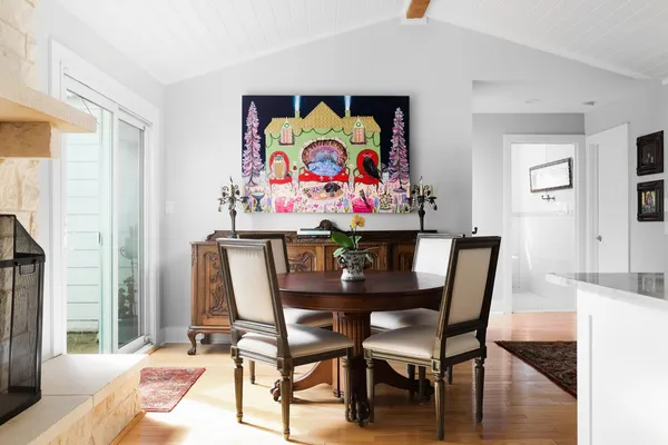 a view of a dining room with furniture one side and wooden floor