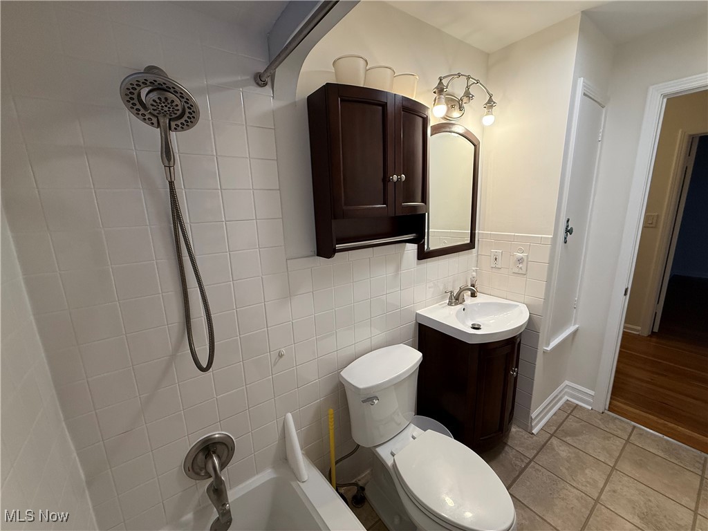 6290 Crossview Road Independence, OH 44131 - Photo 12 of 24 Bathroom featuring tile patterned flooring, vanity, tile walls, and toilet