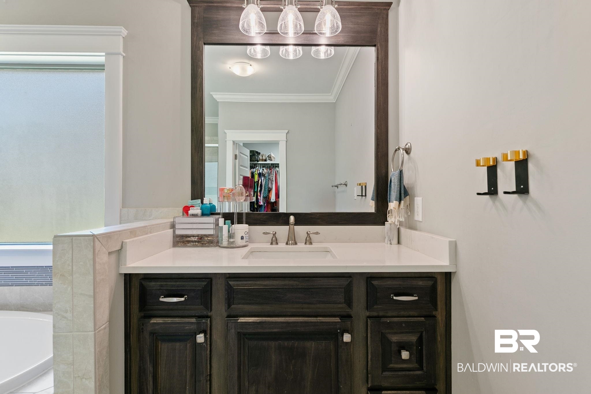 31911 Bobwhite Road Daphne, AL 36527 - Photo 34 of 85 Full bathroom featuring vanity, crown molding, a walk in closet, and a bathtub