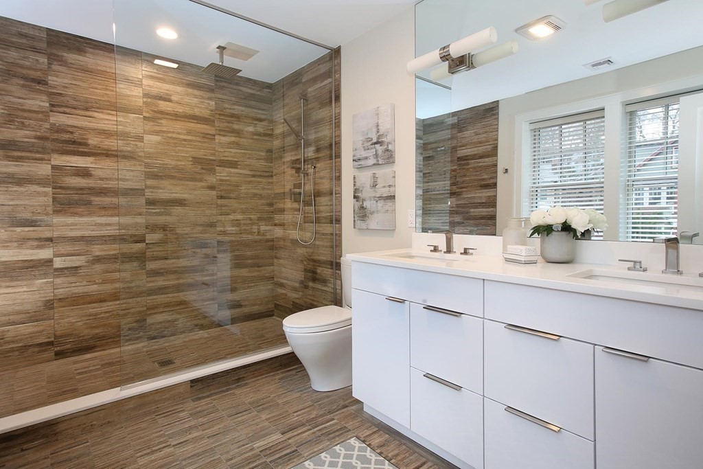 140 Sumner Road, Unit 2 Brookline, MA 02445 - Photo 12 of 20 a bathroom with a sink a toilet a mirror and shower