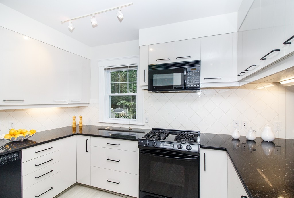 55 Wilde Road Newton, MA 02468 - Photo 11 of 30 a kitchen with stainless steel appliances white cabinets and a stove