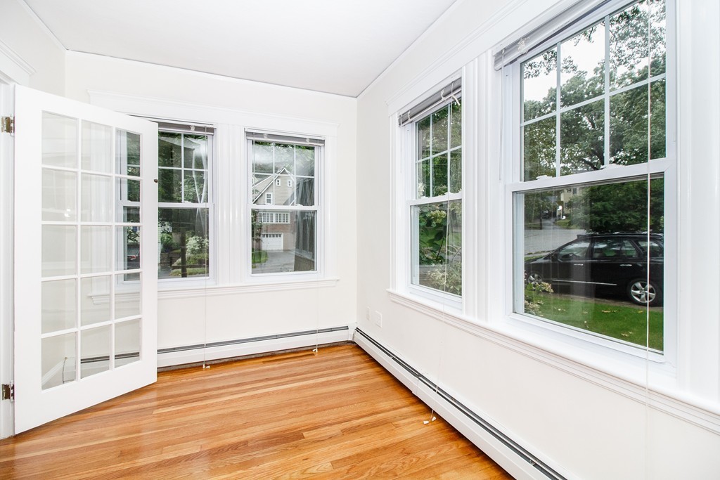 55 Wilde Road Newton, MA 02468 - Photo 17 of 30 a view of an empty room with a window and wooden floor