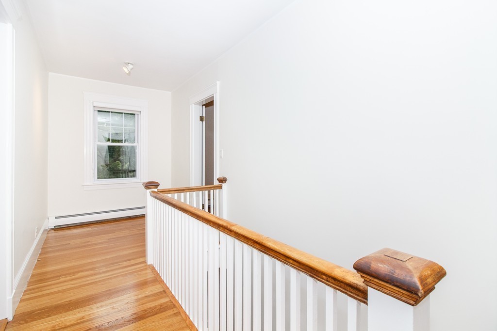 55 Wilde Road Newton, MA 02468 - Photo 18 of 30 a view of a hallway with wooden floor and staircase
